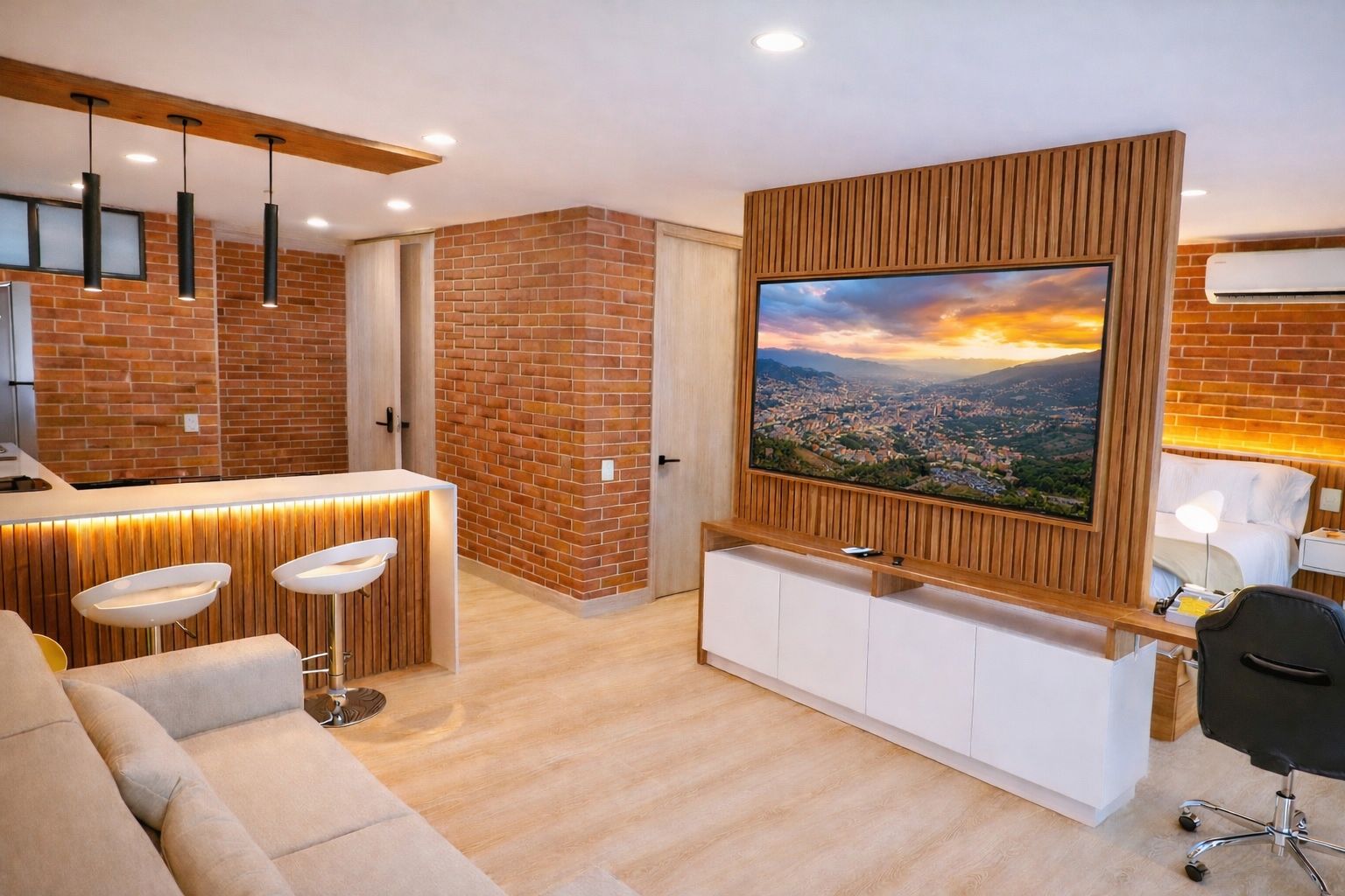 Sala del loft con pared de ladrillo, barra de cocina y TV en panel de madera